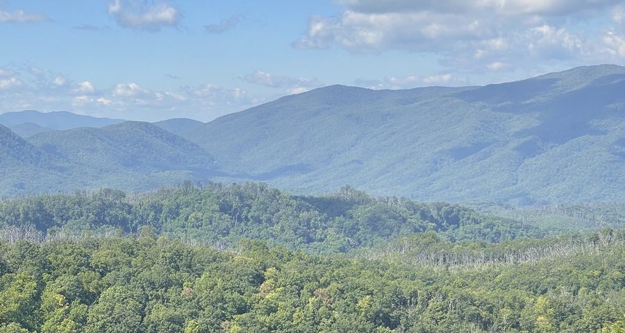 layered mountain ridges under a clear blue sky